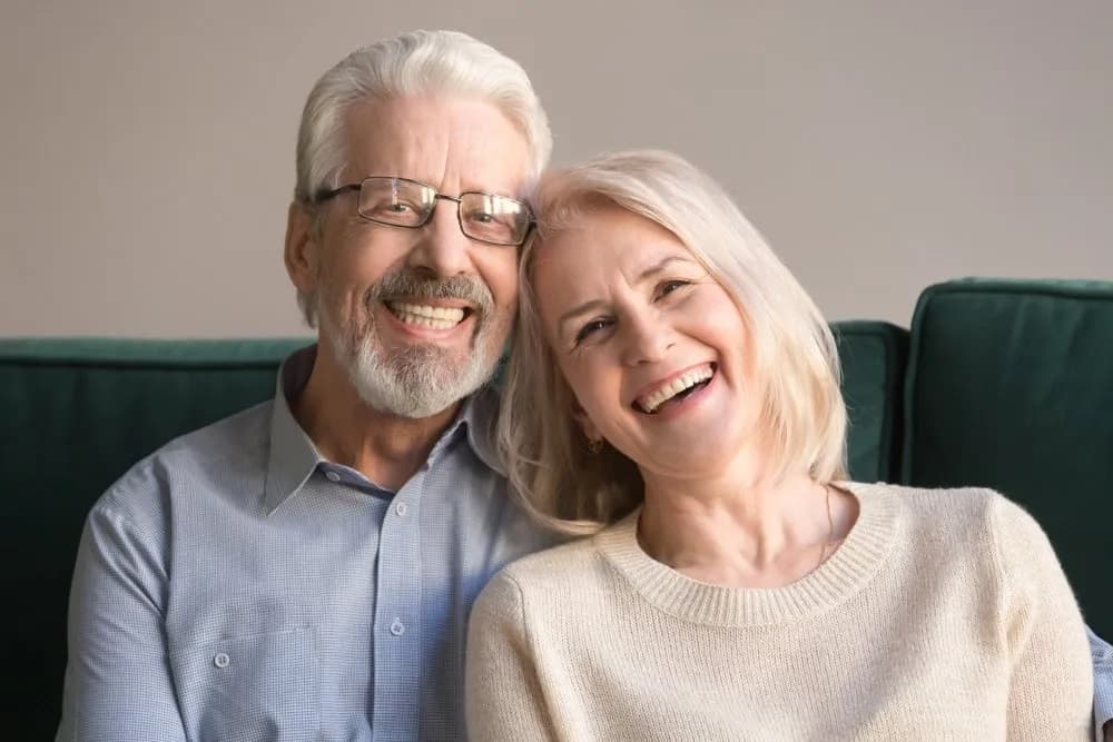 Couple smiling with healthy, restored teeth