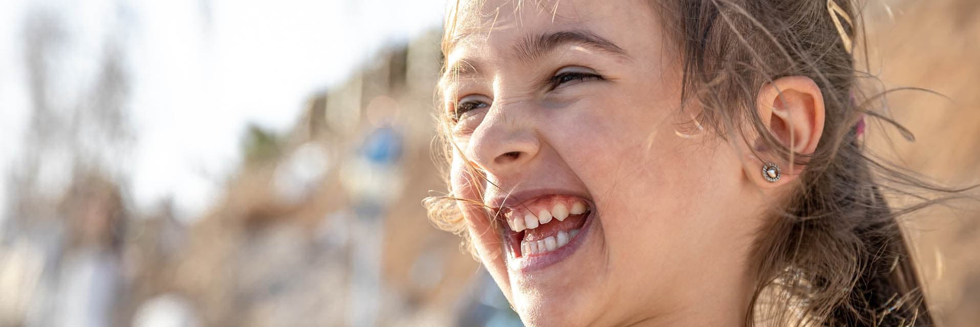 Child laughing with a big, happy smile