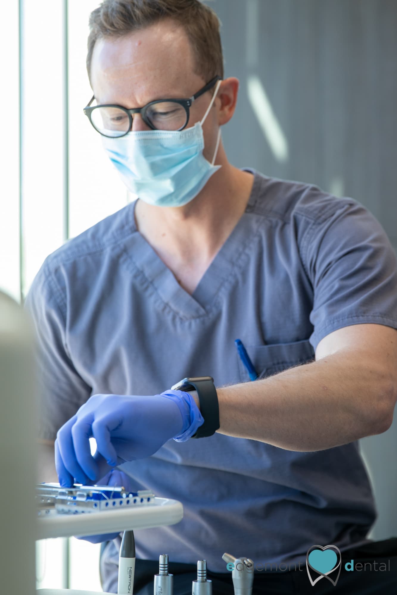 Dentist preparing instruments at Edgemont Dental Clinic